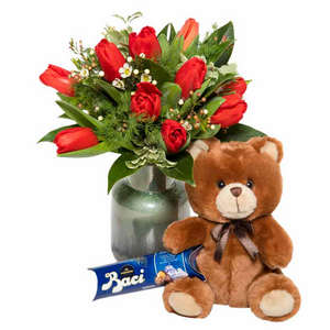 Bouquet of red tulips teddy bear and chocolates